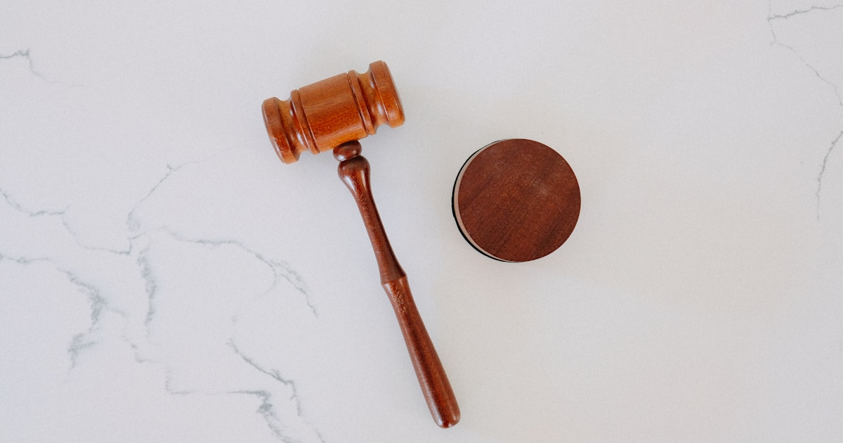 Wooden gavel resting on a white marble surface, representing regulatory enforcement of PHIPA administrative monetary penalties