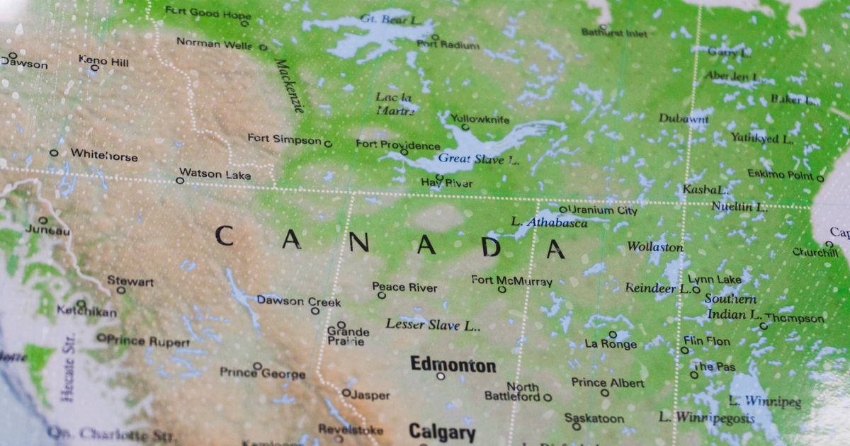 A physical relief map of western and central Canada with the provincial and territorial boundaries drawn as dotted lines, Edmonton and Calgary legible in Alberta